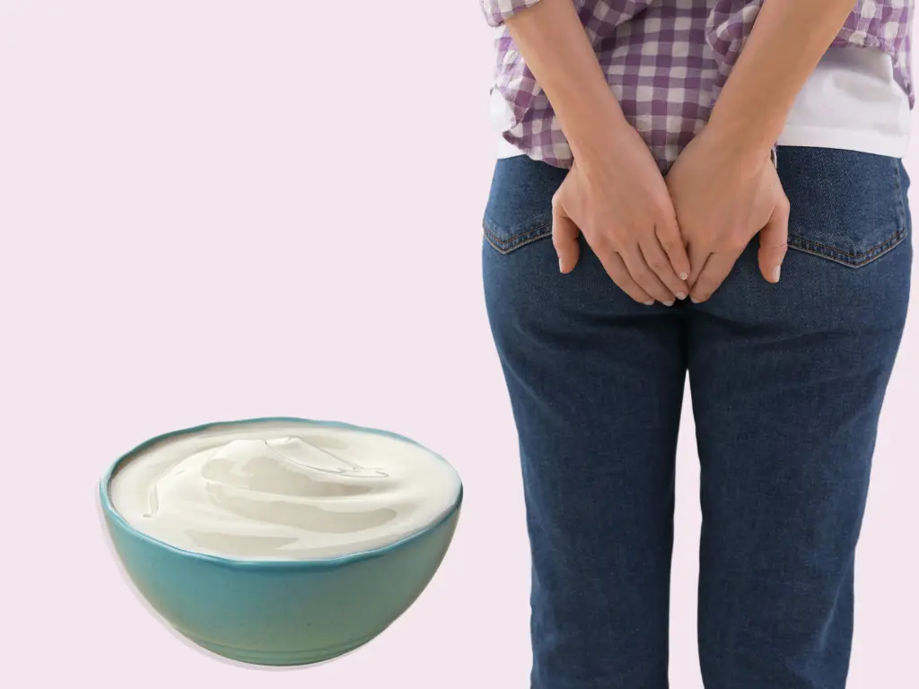 Woman holding her back side singling pain from hemorrhoids and a bowl of greek yogurt