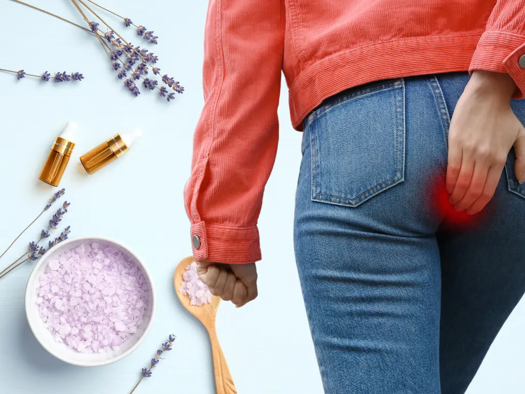 Woman showing pain from hemorrhoids by holding her backside and a bowl of epsom salt