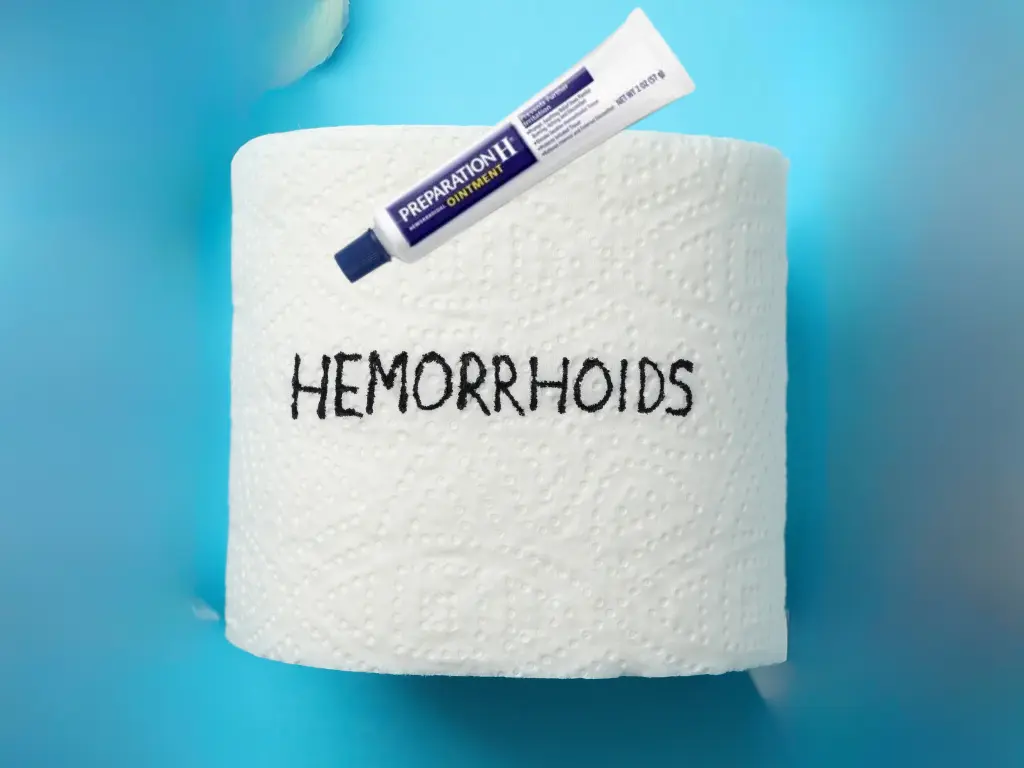a toilet paper with hemorrhoids written on it, and a tube of preparation h cream